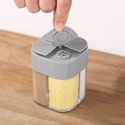 Boîte transparente à épice de poudre de poivre de quatre grilles assaisonnant portatif extérieur de pot